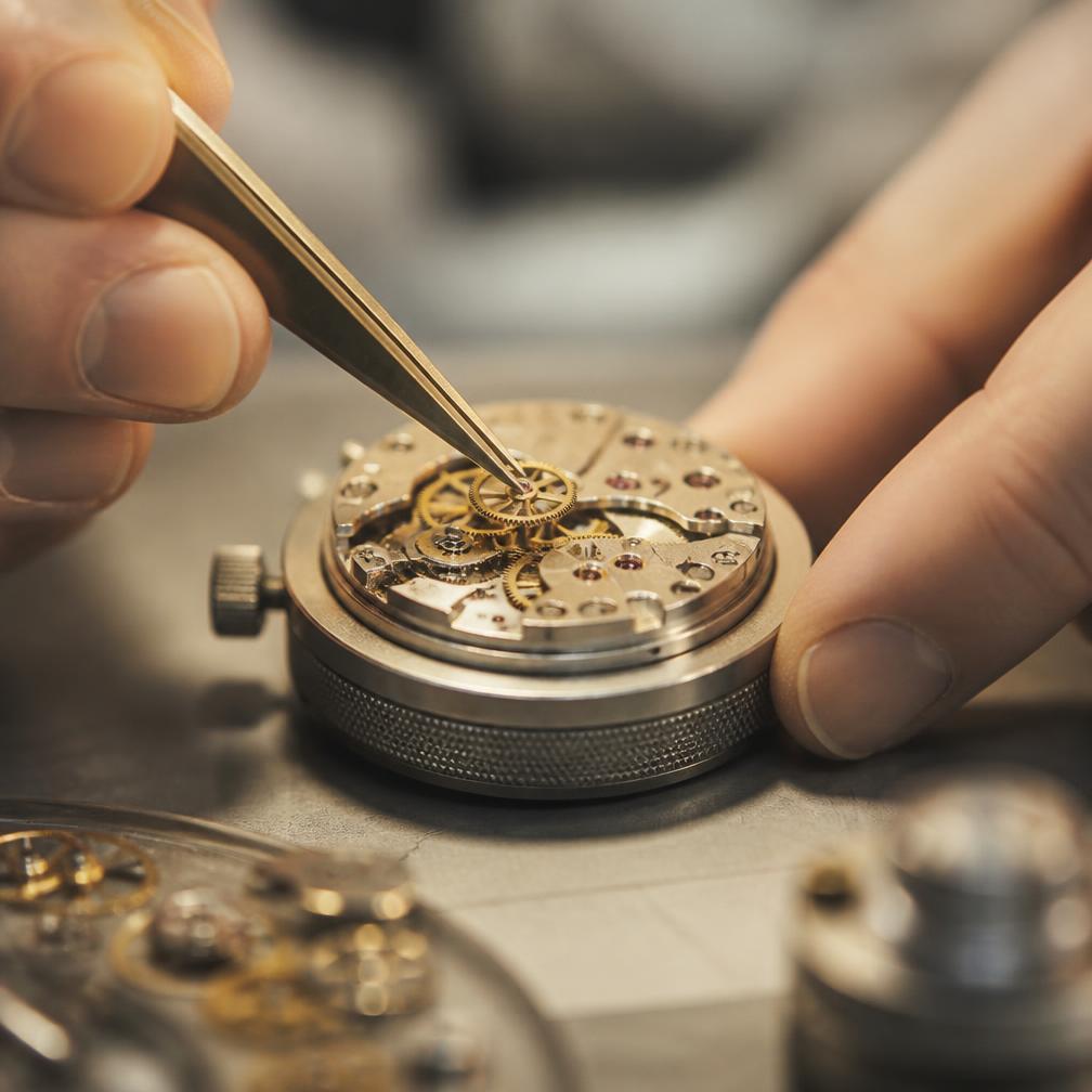 A watchmaker assembling a mechanical movement